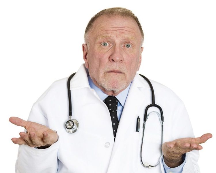 Closeup portrait of clueless senior mature health care professional, old doctor with stethoscope, has no answer, doesn't know right diagnosis, isolated on white background. Emotion facial expression